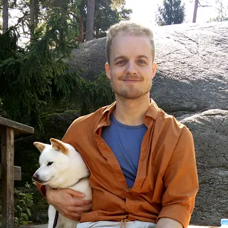 Profile picture of me sitting with my dog in Seurasaari, Helsinki.